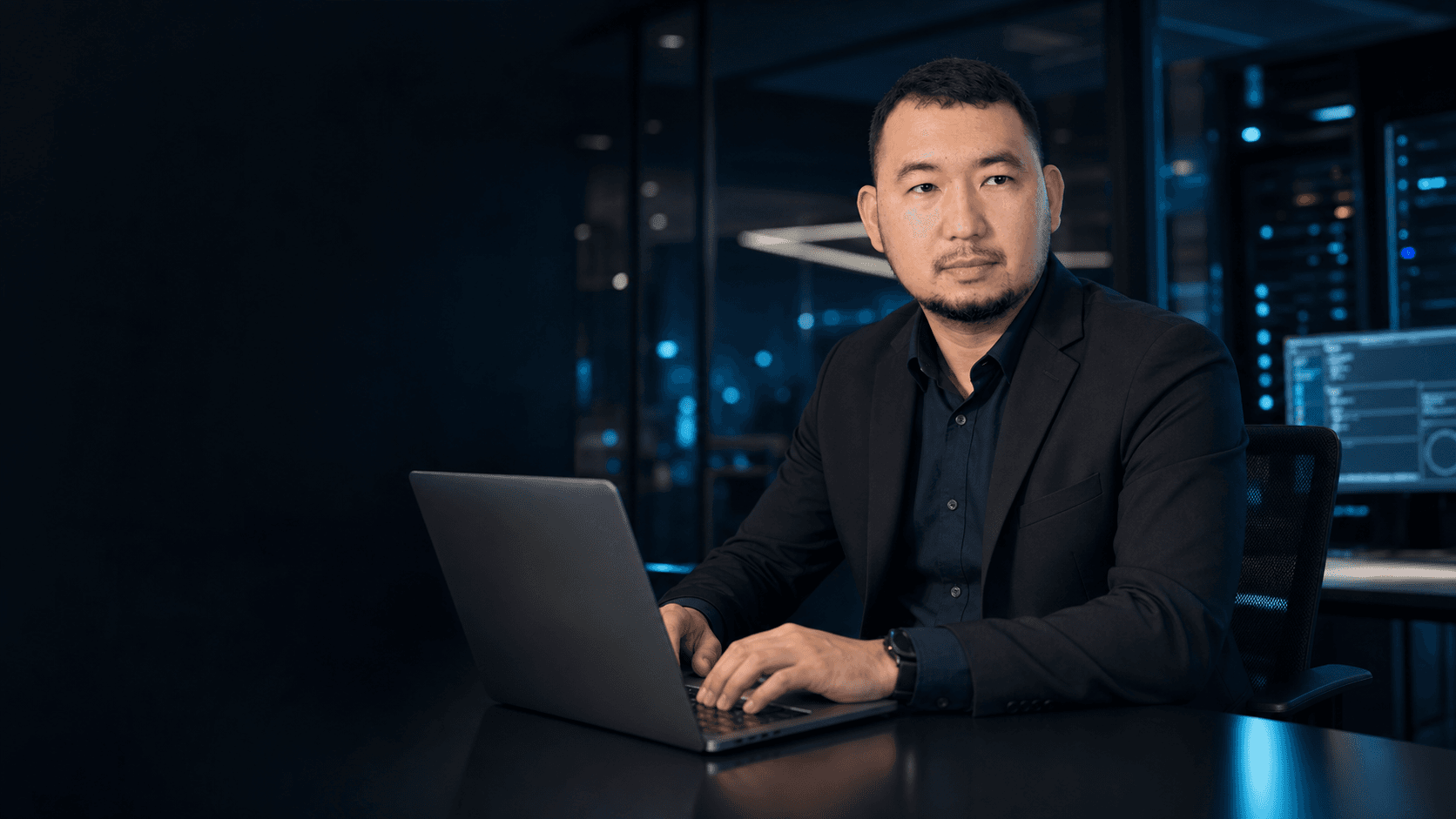 Charles Katada working in a modern office
